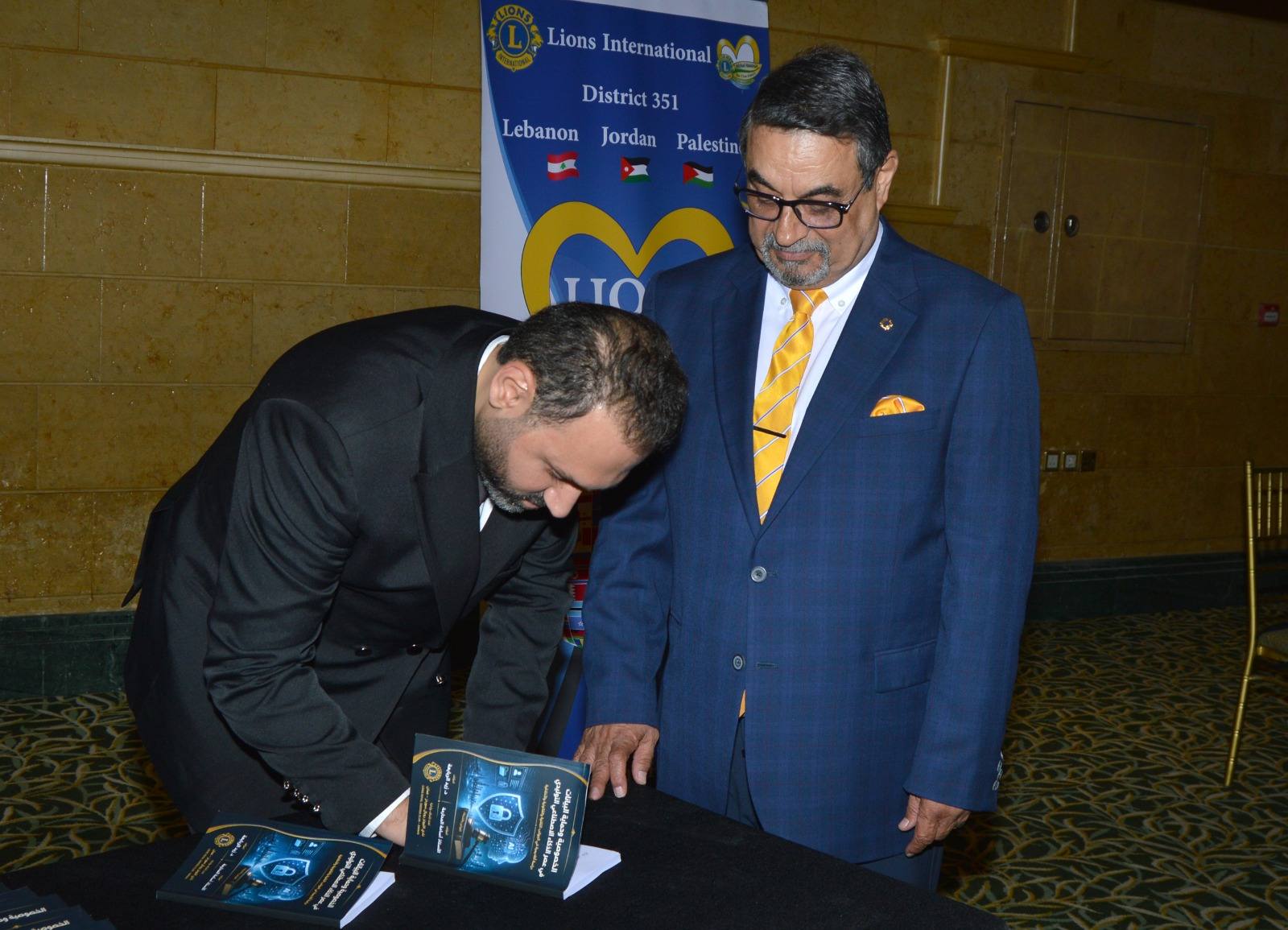 Dr. Zaid Rababah signing copies of Privacy and Data Protection in the Age of Generative AI